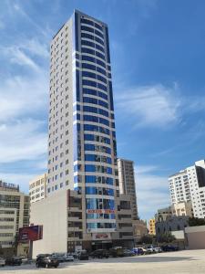 a tall building with blue windows in a city at SIRIUS TOWER in Juffair