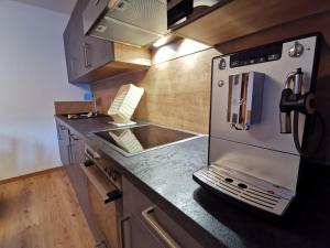 a kitchen with a counter with a sink and a stove at Apart Grafspitz in Ischgl