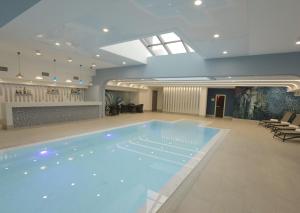 a large swimming pool in a hotel lobby at Dave Hotel Yerevan in Yerevan