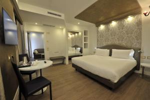 A bed or beds in a room at Al Theatro Palace