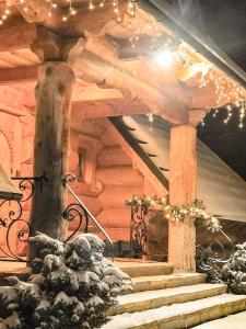 a set of stairs in a log cabin with christmas lights at Krokus Park Residence in Kościelisko