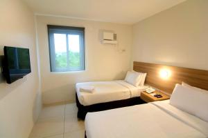 Postel nebo postele na pokoji v ubytování Mango Suites