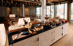 a buffet in a room with tables and chairs at Hotel Maestoso - Lipica in Sežana