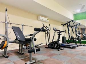 einen Fitnessraum mit mehreren Trainingsgeräten in einem Raum in der Unterkunft BluO Studio5 Golf Course Road - Gym, Terrace Garden in Gurgaon