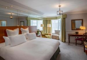 a bedroom with a large white bed in a room at Old Course Hotel St Andrews in St. Andrews