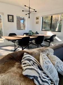 a living room with a table and a couch with pillows at Lakeview Oasis in Queenstown