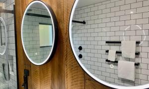 La salle de bains est pourvue d'un miroir et de carrelage blanc. dans l'établissement Lakeview Oasis, à Queenstown 21 autres photos