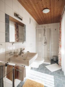 a bathroom with a sink and a toilet at Gästehaus Manuela Puchmayr in Mellau