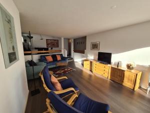 a living room with a couch and a television at Alpen-fewo, Denter Vias 10, Casa Alma in Flims
