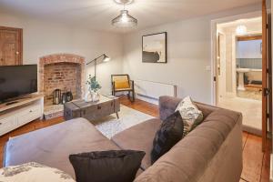 a living room with a couch and a television at Host & Stay - Sleepers @ No.8 in Pickering