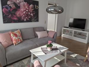 a living room with a couch and a table at Cozy Apartment with Parking Garage near Outlet in Metzingen