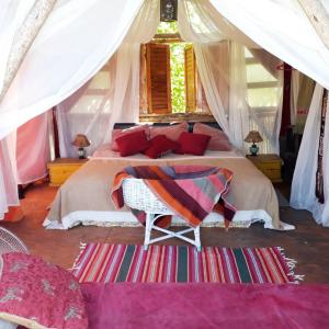 a bedroom with a large bed in a tent at Al Aire Libre in San Rafael