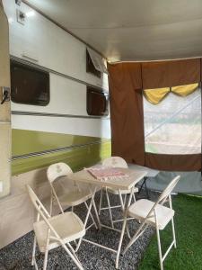 a table and two chairs in a trailer at Trailer, Esporte e Amigos in Atibaia