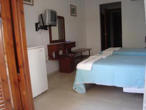 A bed or beds in a room at Dimitris Rooms