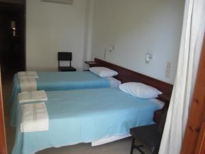 A bed or beds in a room at Dimitris Rooms