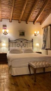a bedroom with a large white bed with two lamps at Piccolo Mondo Hotel in Ağva