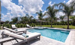 a swimming pool with two lounges and two lounge chairs at The Glissandro in Orlando