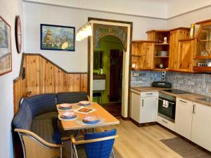 a kitchen with a table with plates on it at Bodega Apartment in Villach