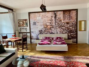 a living room with a bed and a dining room at Bodega Apartment in Villach