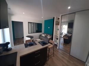 a kitchen and living room with a couch and a table at Inviting 1-Bed Apartment in Grezieu-la-Varenne in Grézieu-la-Varenne