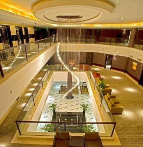 a lobby of a cruise ship with a chandelier at All Seasons Hotel Al Ain - Previously City Seasons in Al Ain