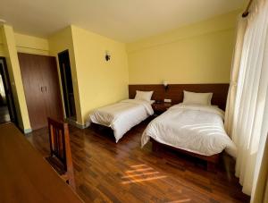 Postel nebo postele na pokoji v ubytování HOTEL CLAIRE INN