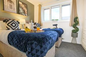 a bedroom with two beds and a window at Pannier House - Central MK - Free Parking, Garden, Smart TVs with Netflix by Yoko Property in Milton Keynes
