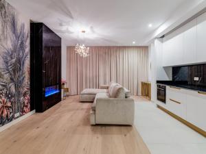 a living room with a couch and a tv at Vida Herastrau, luxury 2 rooms apartment in Bucharest
