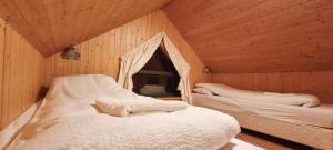 a bedroom with two beds in a wooden room at Dixon Cabin nr. 7 / Dixon sumarhús nr. 7 @Kirkjubraut in Talknafjordur +33 photos