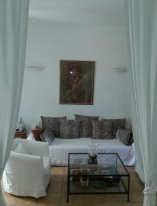 a living room with a couch and a glass table at Tranquil Villa with Sea view in Ammopi Karpathos in Amoopi