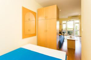 a bedroom with a bed and cabinets and a sink at Apartments Radić in Dubrovnik