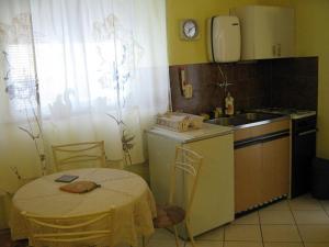 a small kitchen with a table and a sink at Studio apartment in Novi Vinodolski with terrace, air conditioning, WiFi 4208-1 in Novi Vinodolski +20 photos