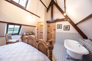 a bedroom with a bed and a sink at The Tiny Chapel in Hexham