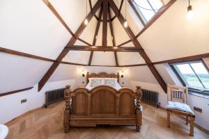 a bedroom with a wooden bed in a attic at The Tiny Chapel in Hexham