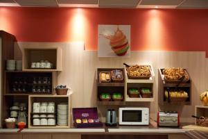 a kitchen with a counter with food on it at Ace Hotel Annecy in Annecy