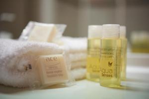 a close up of two bottles of soap and towels at Ace Hotel Annecy in Annecy