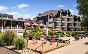 a hotel with a resort with chairs and a pool at Hotel Moselblick in Winningen