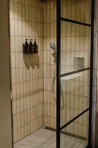 a bathroom with a shower with a glass door at Boutique Hotel & Restaurant Frenchie in Haarlem