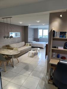 a living room with a couch and a table at Majestic Isal-inn in Aix-les-Bains