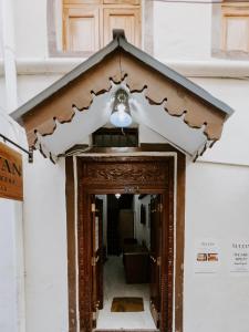 a door to a building with a light above it at Sultan House in Zanzibar City