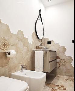 a bathroom with a sink and a toilet and a mirror at Le Caravelle Affittacamere in Genova