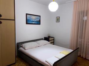 Postel nebo postele na pokoji v ubytování Apartmani Infinity