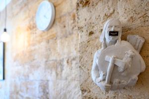 a statue of a man holding a cross and a clock at Уютная квартира недалеко от Дерибасовской in Odesa +11 photos