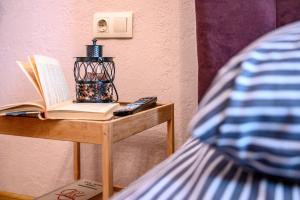a table with a book and a remote control on it at Уютная квартира недалеко от Дерибасовской in Odesa