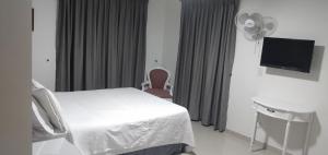 Postel nebo postele na pokoji v ubytování Hotel Suite Santa Rosa
