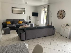 a living room with a couch and a table at Ferme de villardelle Maison de vacances in Courmont