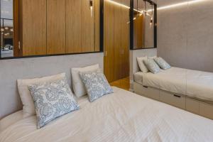a bedroom with two beds and a mirror at Apartament 309 in Boszkowo +27 photos