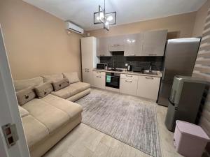 a living room with a couch and a kitchen at VillaVersa in Ulcinj