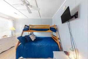 a bedroom with a bunk bed and a tv at Mallard Lakes -- 38287 Cardinal #139 in Selbyville +36 photos