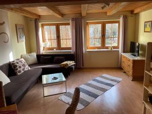 a living room with a couch and a table at Iseler Mühle in Bremervörde